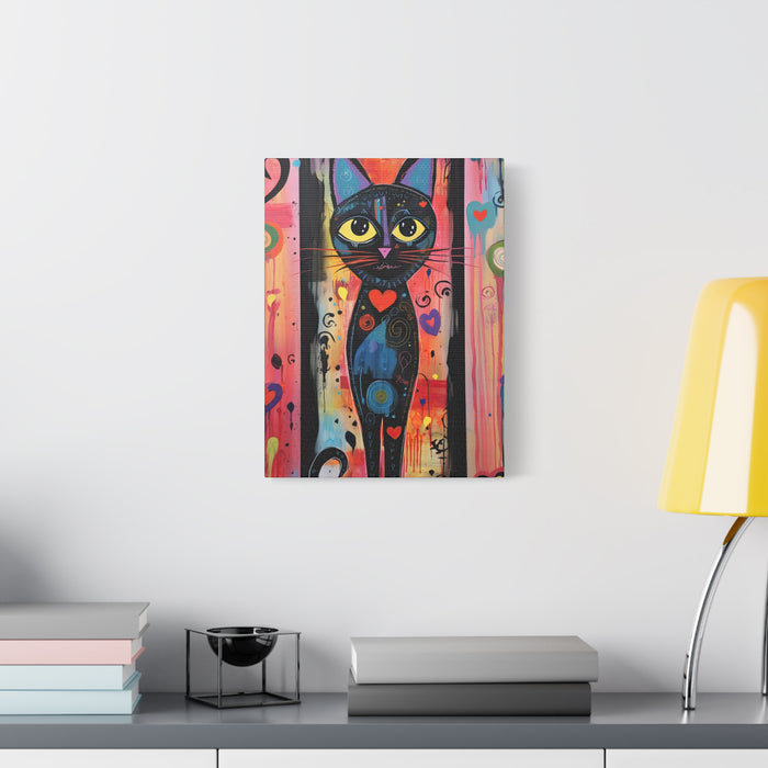 Colorful abstract painting of a black cat on a white wall above a desk with books and a lamp.