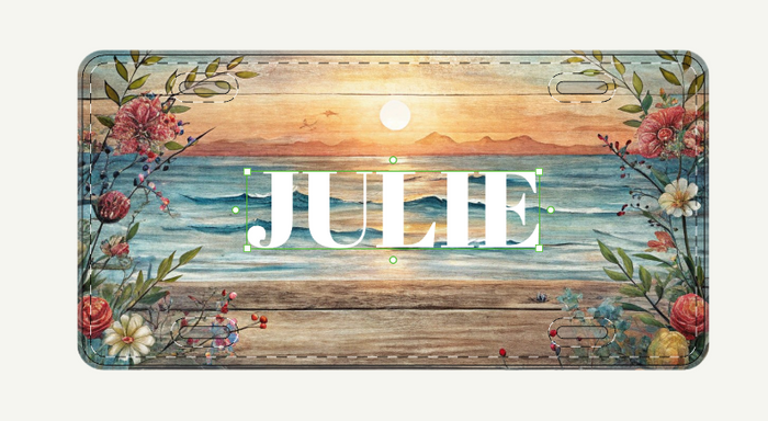 Personalized license plate with a beach scene and floral design, featuring the name 'JULIE'.