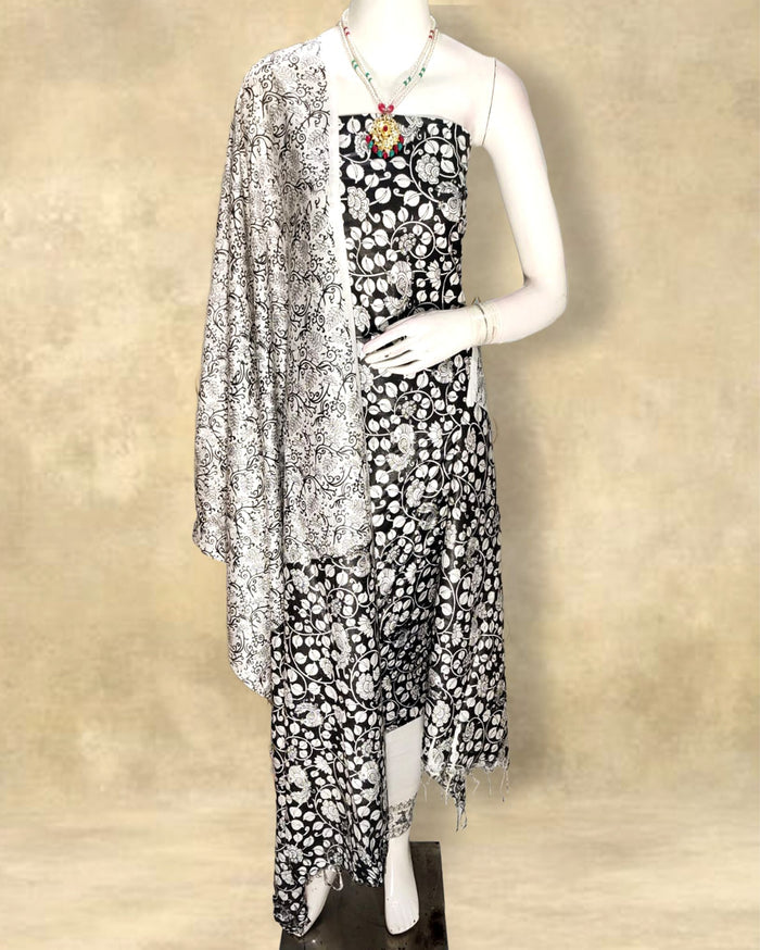 Black katan silk unstitched suit set with a dense white floral hand block print across top, bottom and fringed dupatta