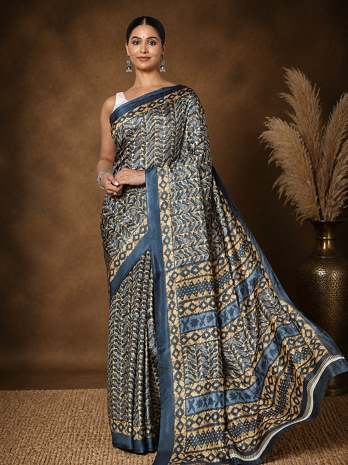 Dark blue and tan printed saree with geometric, leaf-like motifs and a dark blue border, styled with a reference blouse.