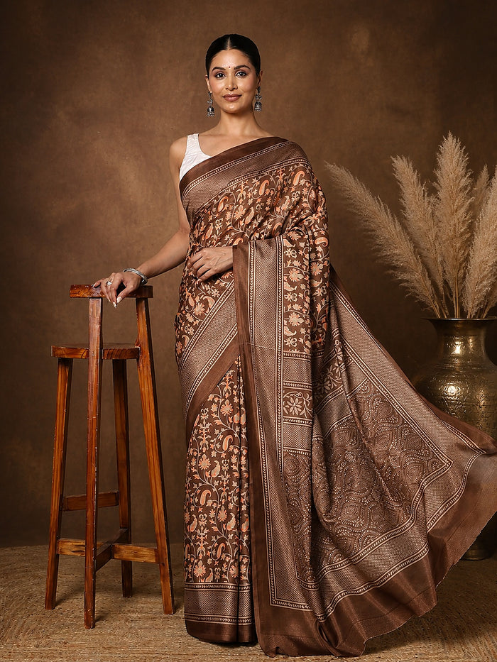 Brown printed saree in a floral paisley print with orange and green, a wide lattice border and a large medallion pallu.