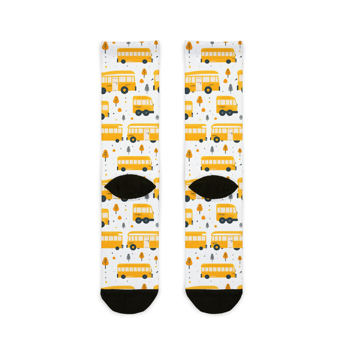 Pair of socks with yellow school bus pattern on a white background