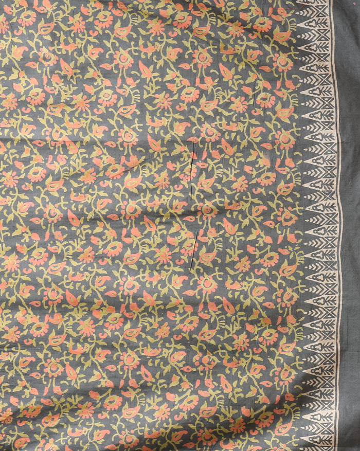 Charcoal grey and olive green Katan silk unstitched suit set with all-over floral paisley block print in muted earth tones, peach and pale yellow accents and a tasselled dupatta