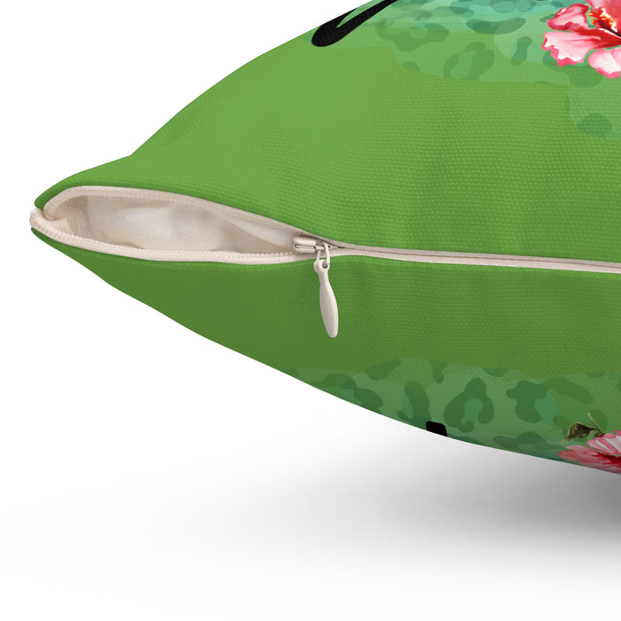 Green pillow with floral design on a white background