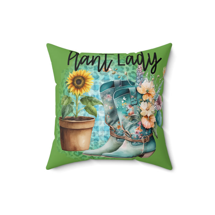 Decorative pillow with floral boots, sunflower, and text 'Plant Lady' on a green background