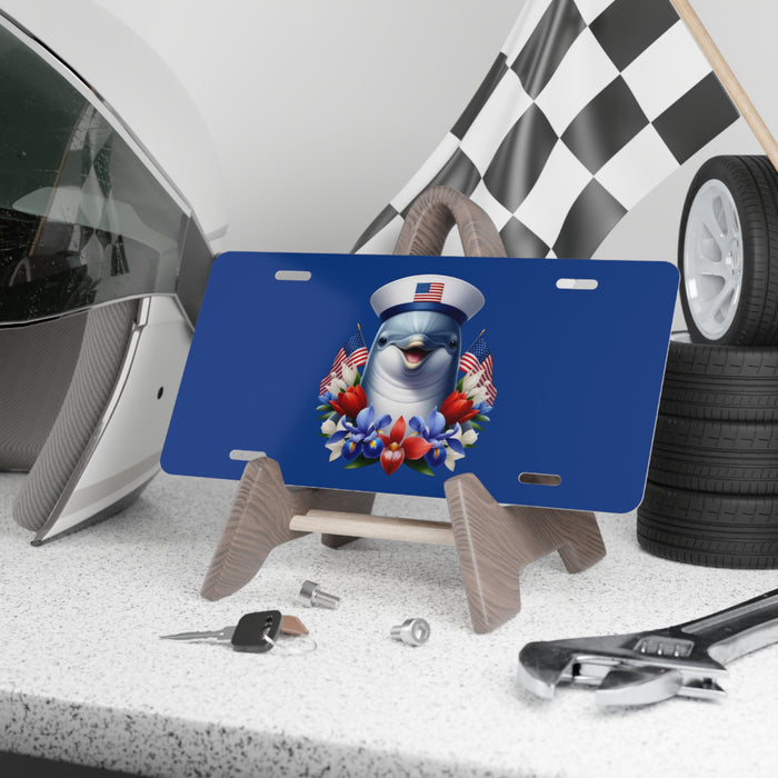 Blue license plate with a cartoon character and American flags on a stand in a garage setting.