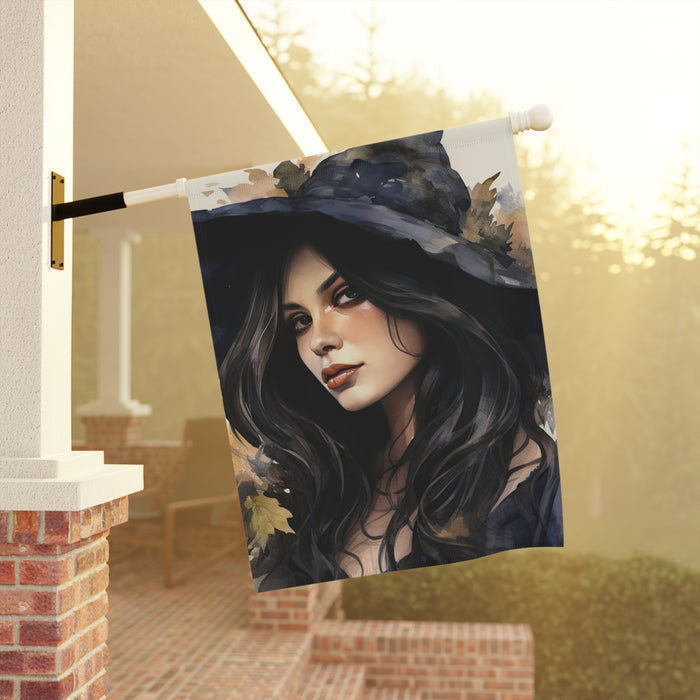 Decorative flag with a witch design hanging on a porch