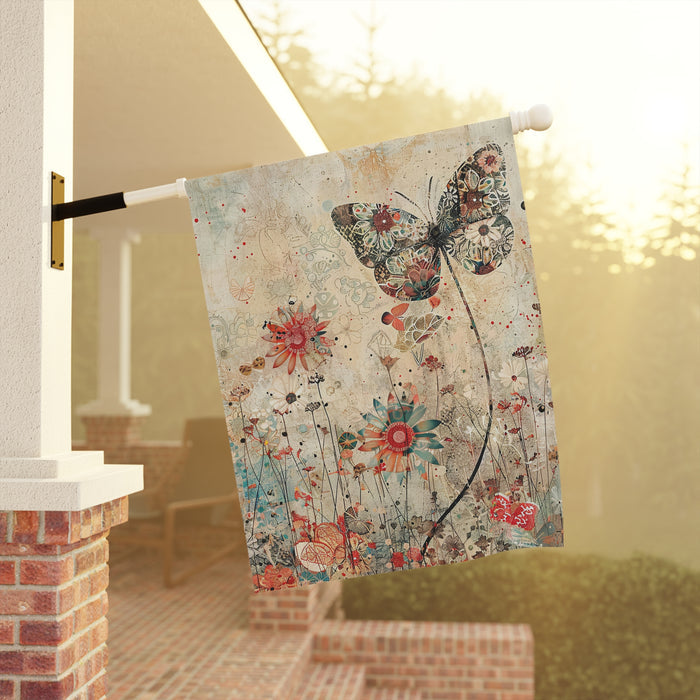 Decorative garden flag with butterfly and floral design on a pole outdoors.