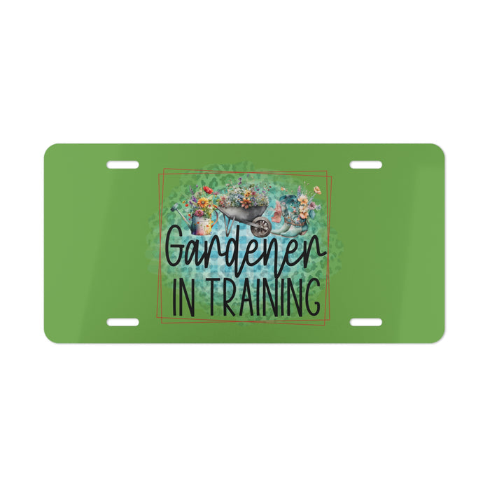 Green license plate with 'Gardener in Training' text and gardening-themed design on a white background