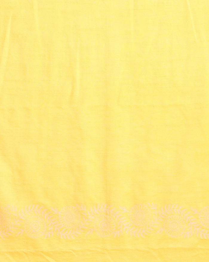 Golden yellow katan silk unstitched suit set with a small white leaf hand block print and a circular floral band with fringe on the dupatta