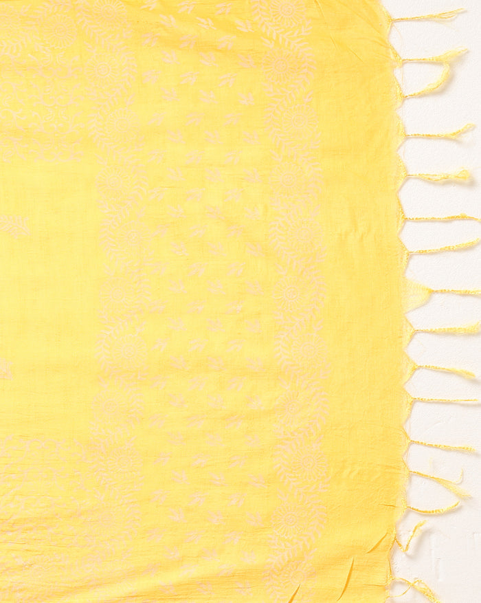 Golden yellow katan silk unstitched suit set with a small white leaf hand block print and a circular floral band with fringe on the dupatta
