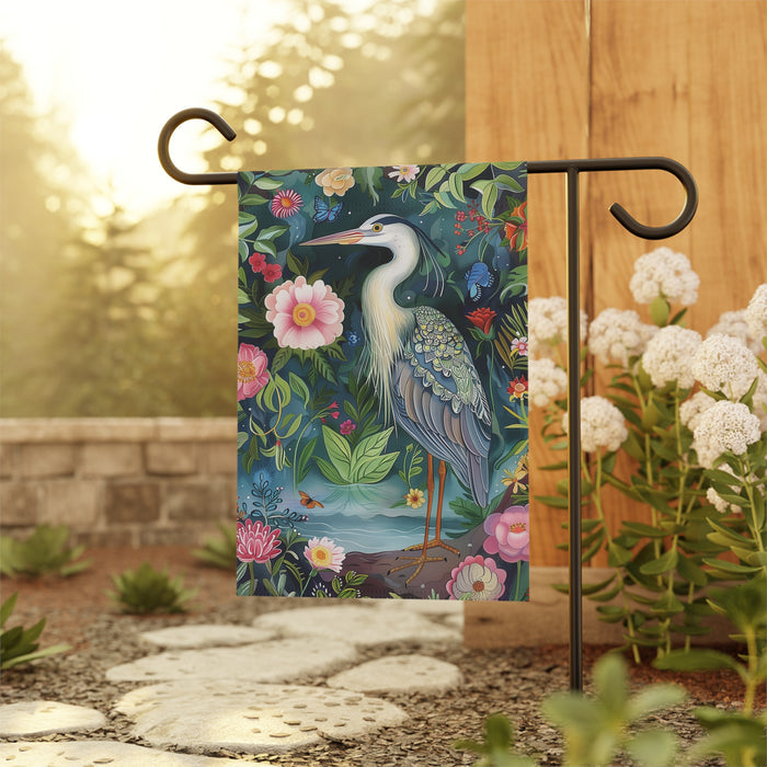 Decorative garden flag with a heron and flowers on a stand outdoors.