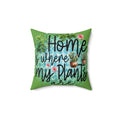 Decorative pillow with 'Home is where my plants are' text and plant illustrations on a green background.