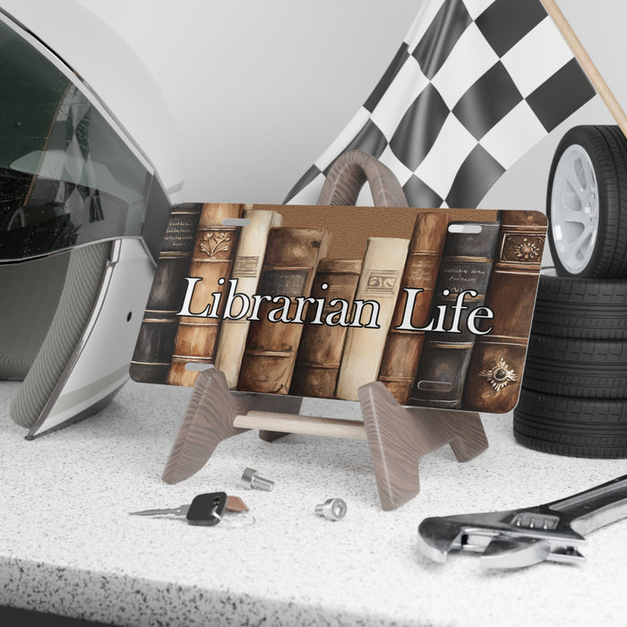 License plate with 'Librarian Life' design on a car dashboard with tools and a helmet.
