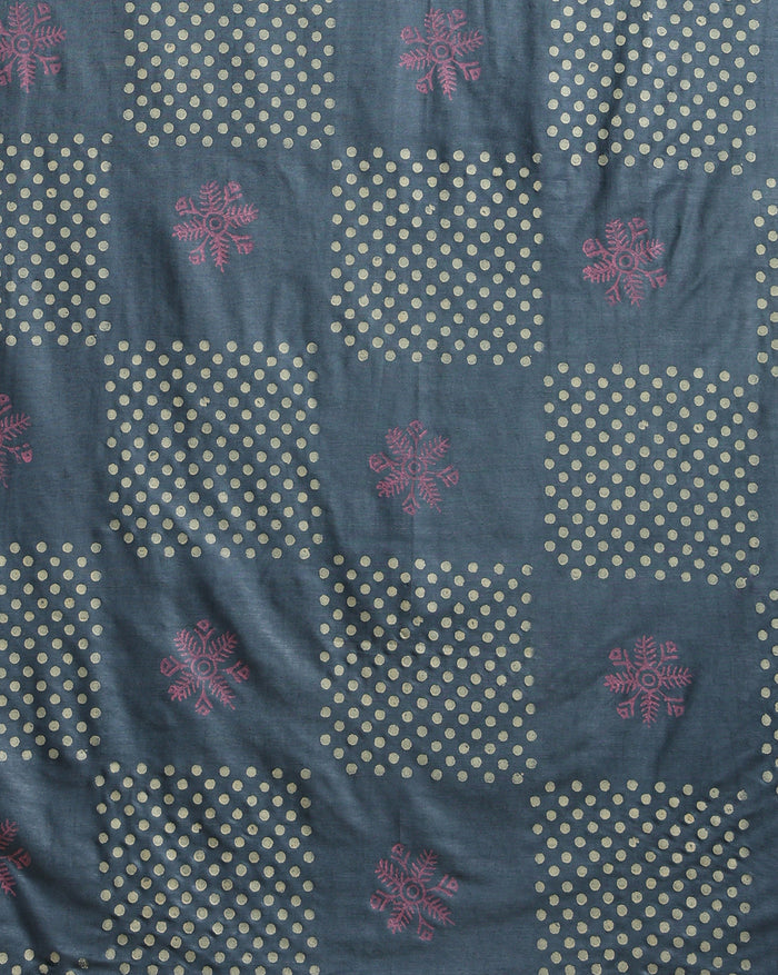 Deep metallic blue Katan silk suit set hand block printed with asymmetric sections of off-white polka dots and muted pink abstract florals, with a scrolling vine border on the dupatta.