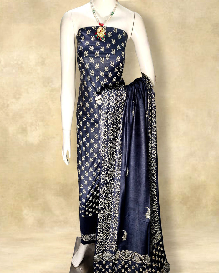 Deep navy blue katan silk unstitched suit set hand block printed with fine ivory sprigs, with a dupatta edged in wide ivory scrollwork and circular motifs.