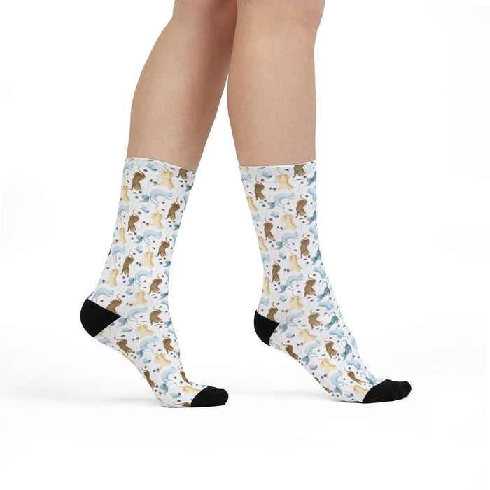 Patterned socks with animal design worn by a person on a white background
