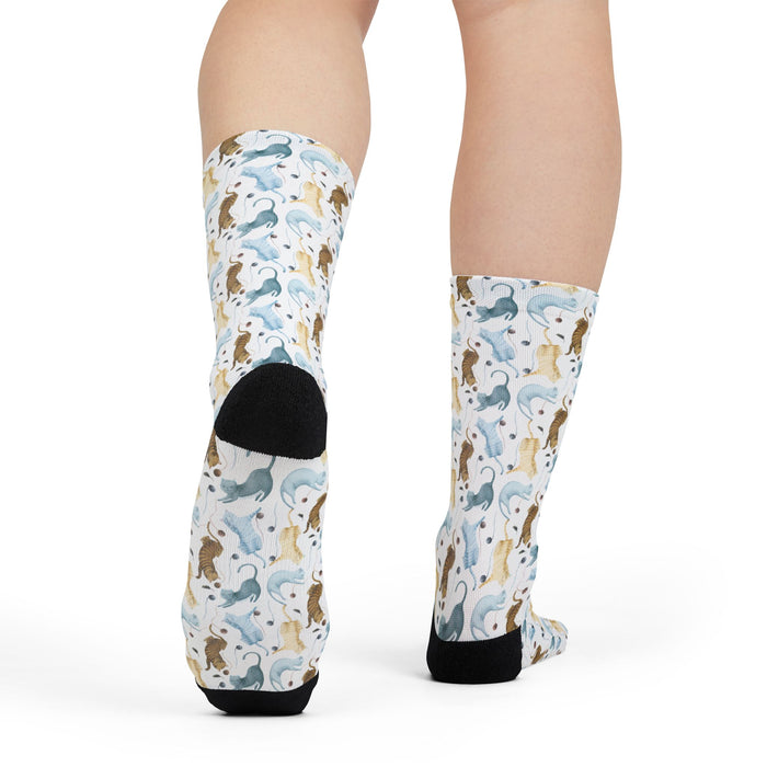 Patterned socks with animal design worn by a person on a white background