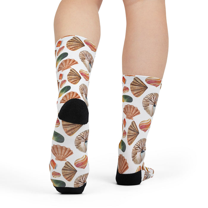 Colorful shell-patterned socks on a plain background