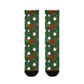 Green socks with festive design featuring birds and text on a white background