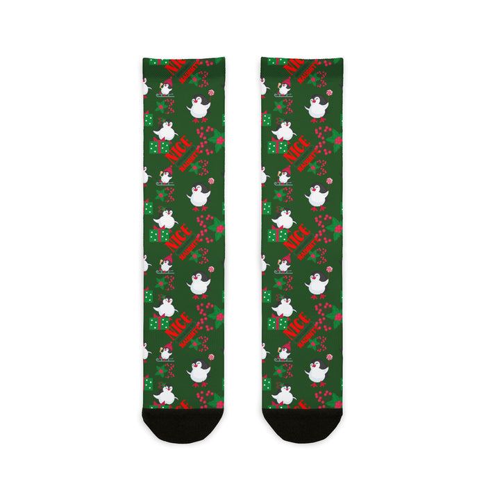 Green socks with festive design featuring birds and text on a white background