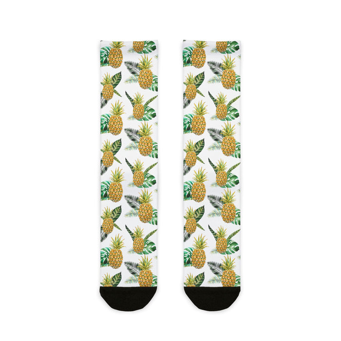 Two socks with pineapple pattern on a white background
