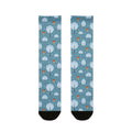 Two socks with a pattern of trees and hot air balloons on a blue background.