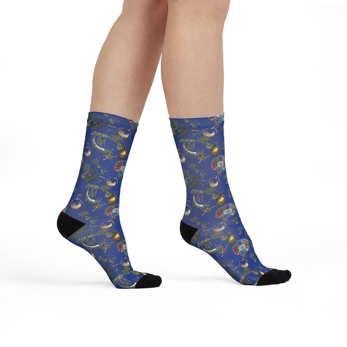 Blue socks with a pattern worn by a person on a white background