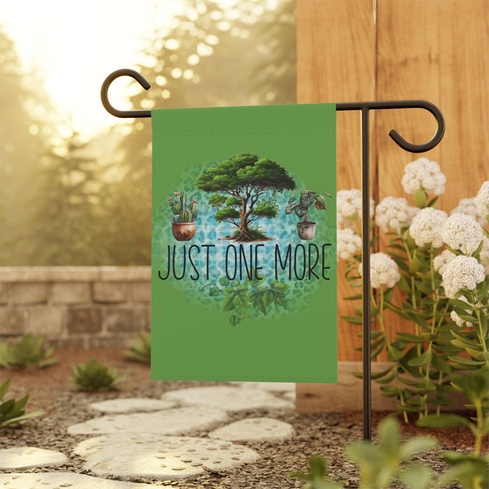Garden flag with nature design and 'Just One More' text on a stand outdoors.
