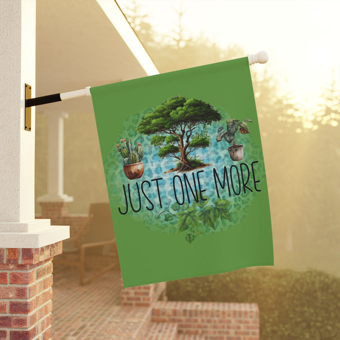 Decorative garden flag with a tree and plants design on a porch