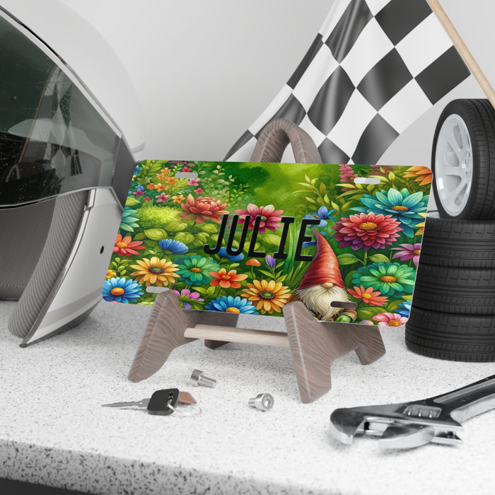 Personalized Gnome Vanity Front License Plate sitting on a shelf propped up on a display stand