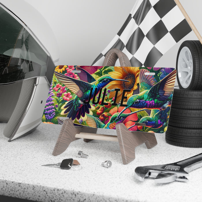 Personalized Hummingbird Custom License Plate Vanity Plate displayed on a stand on a shelf.