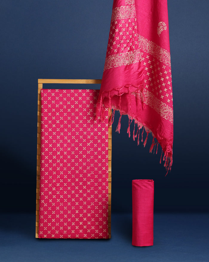 Magenta pink Katan silk suit set hand block printed with an all-over off-white cross motif, with floral scroll borders and fringed ends on the dupatta.