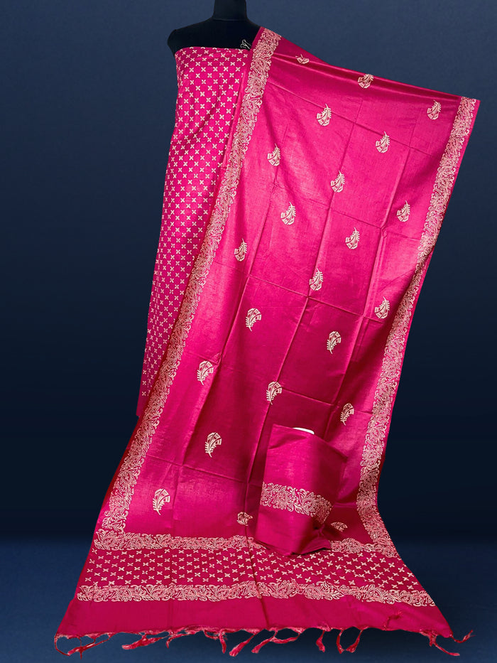 Magenta pink Katan silk suit set hand block printed with an all-over off-white cross motif, with floral scroll borders and fringed ends on the dupatta.