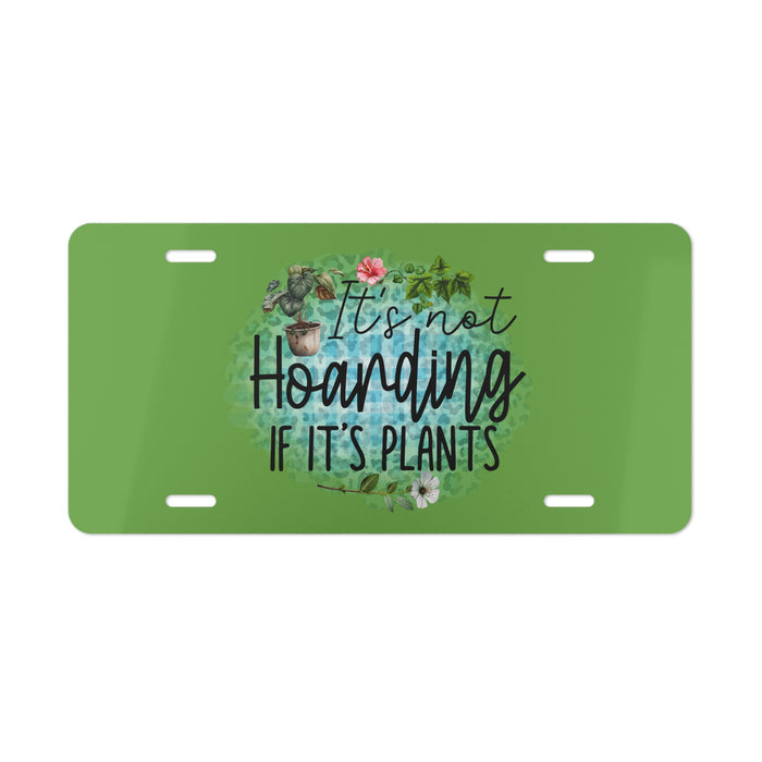 Green license plate with plant-themed text and illustrations on a white background