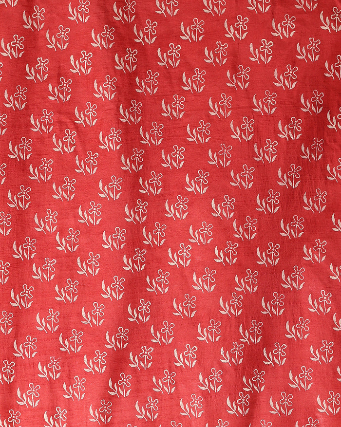 Deep red katan silk unstitched suit set hand block printed with small white flowers, with a dupatta showing a vertical geometric border and a wide printed hem.