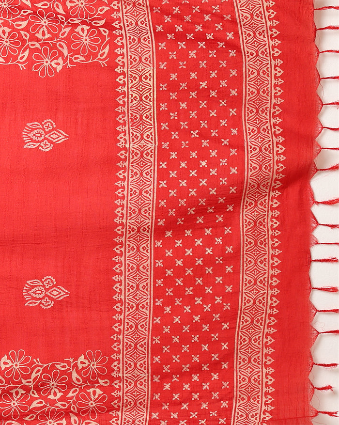 Unstitched red Katan silk suit set block printed with scattered cream and white floral and geometric motifs, a plain unprinted bottom, and a dupatta with a wide floral panel border and a geometric band along the lower edge.