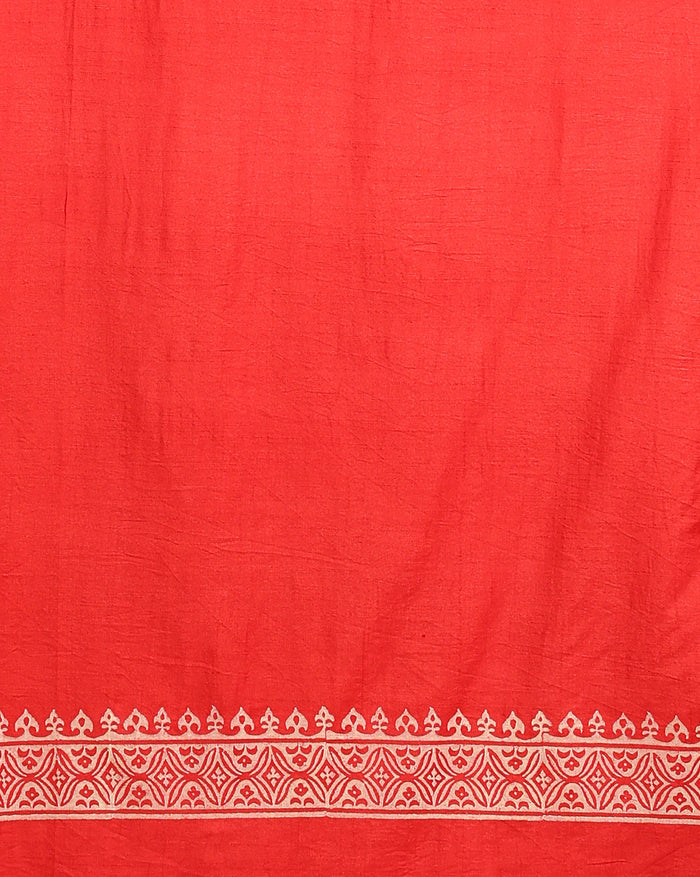 Unstitched red Katan silk suit set block printed with scattered cream and white floral and geometric motifs, a plain unprinted bottom, and a dupatta with a wide floral panel border and a geometric band along the lower edge.