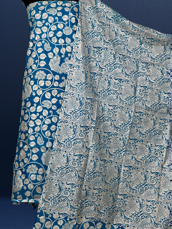 Royal blue Katan silk unstitched suit set with medium-scale cream floral and paisley block print, light pink detail inside the blooms and a tasselled dupatta edge