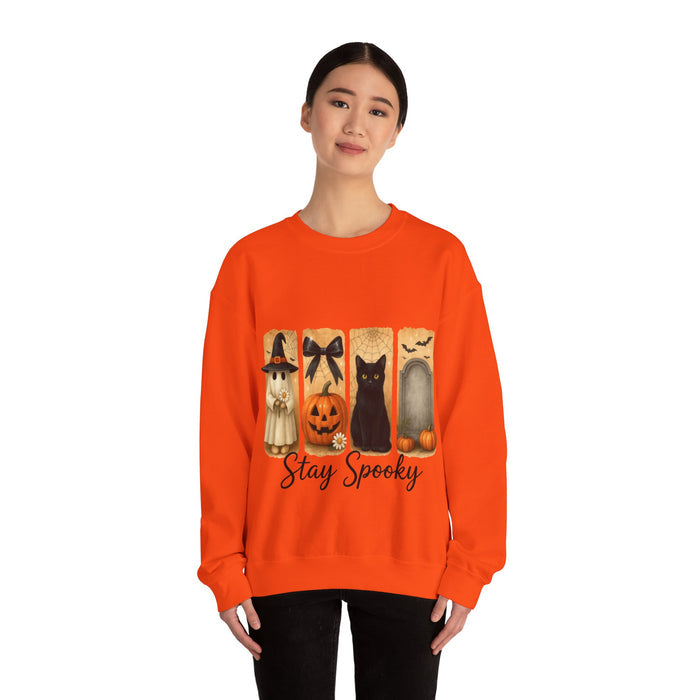 Person wearing an orange sweatshirt with Halloween-themed design and text.