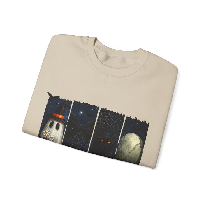 Folded beige sweatshirt with a graphic design of a ghost, moon, and spider web on a white background