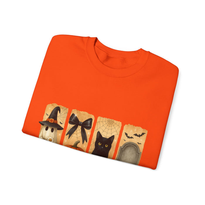 Folded orange shirt with Halloween-themed design on a white background