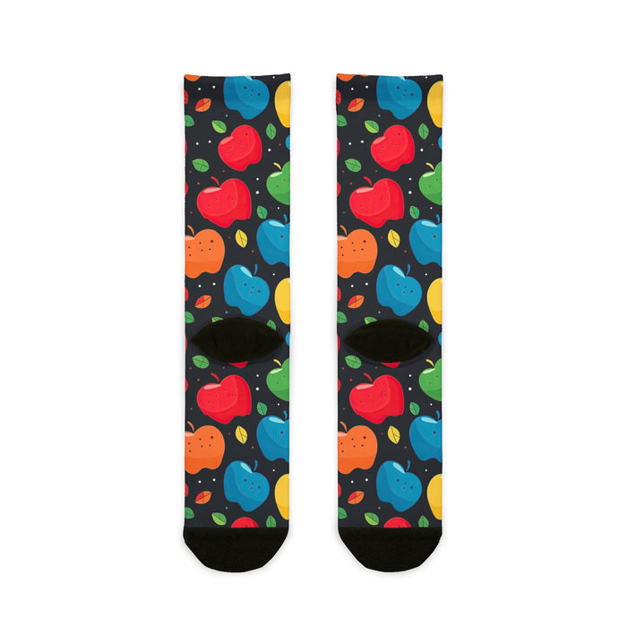 Colorful apple-patterned socks on a black background