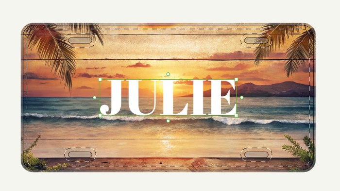 License plate with a beach sunset design and the name 'JULIE' on it.