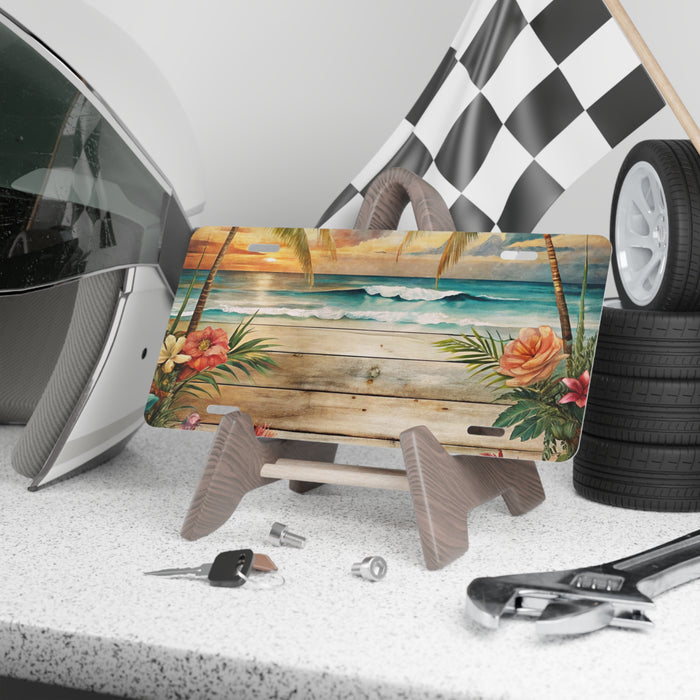 Decorative license plate with tropical design on a car dashboard with tools and a helmet.