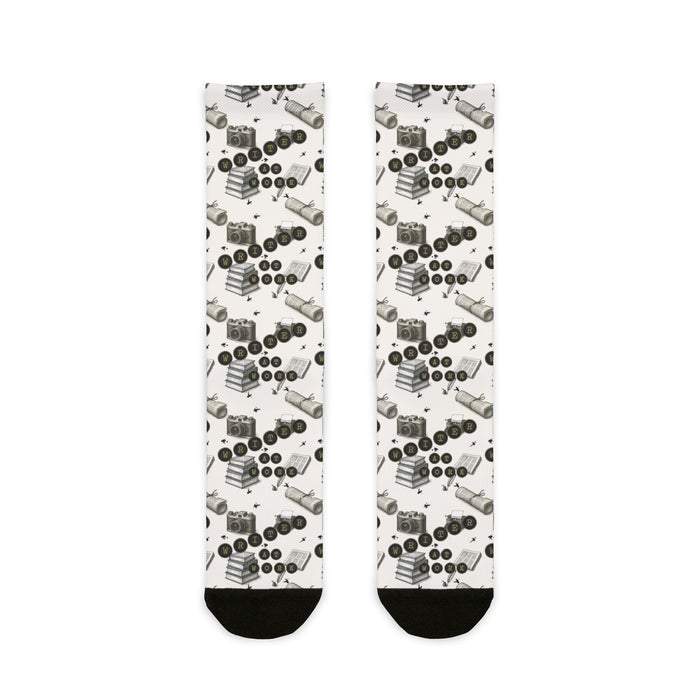 Pair of socks with a pattern of black and white shapes on a white background