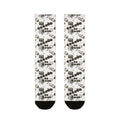 Pair of socks with a pattern of black and white shapes on a white background