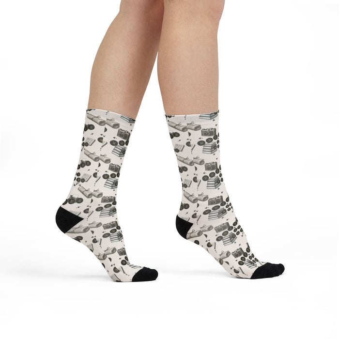 White socks with black pattern worn by a person on a white background