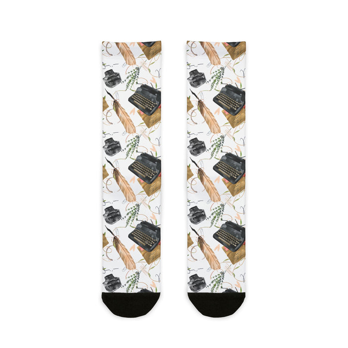 Socks with typewriter and feather pattern on a white background